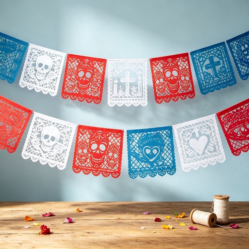 Artisanal papel picado banners for ofrenda with traditional laser cut motifs